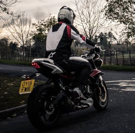 Motorcyclist riding on country lanes